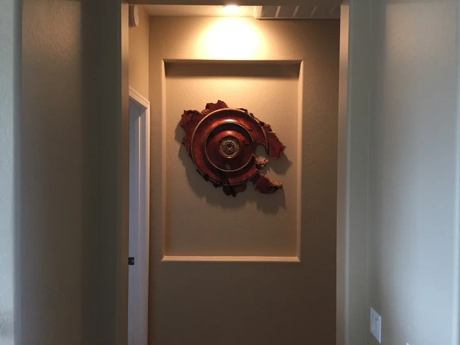 Wood sculpture installed in a hallway