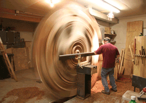 Dave Barkby turning a large wood sculpture in his workshop